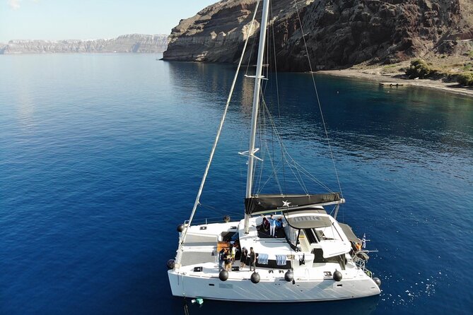 Half-Day Exclusive Catamaran Cruise in Santorini with Meal and Open Bar - Swimming near the volcano and hot springs