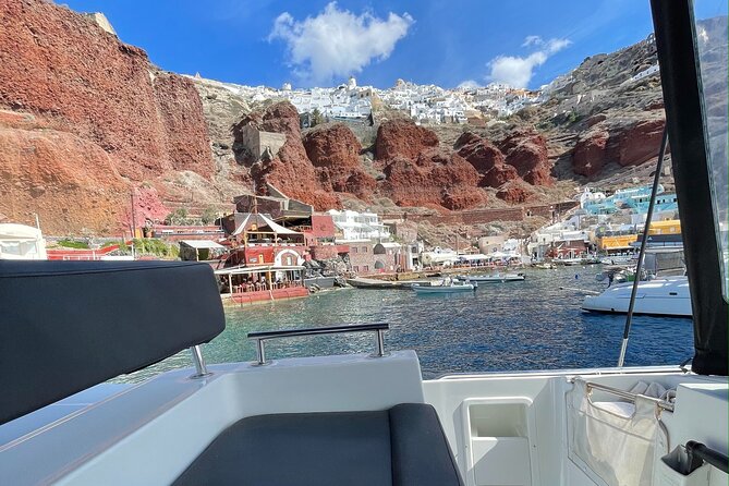 Half Day Premium Catamaran Cruise in Santorini including Oia - The lighthouse adds a quieter coastal view