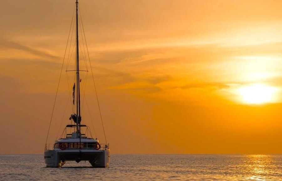 Milos: Kleftiko Sunset Catamaran Cruise with Meal & Drinks - Leaving Adamantas with coffee and local snacks
