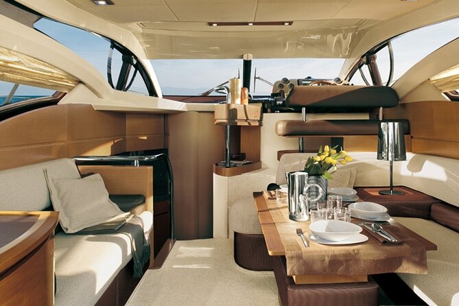 Private Motor Yacht Cruise with BBQ, Open Bar & Transfers - The caldera coast, lighthouse, and Ammoudi views