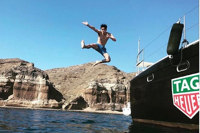 Santorini Adventurous Catamaran Experience with Snorkeling - The Akrotiri lighthouse and the southern coast
