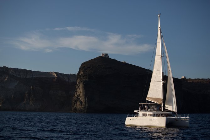 Santorini:All-inclusive Catamaran Cruise with Thirassia Stop - Red Beach and the dark volcanic shore