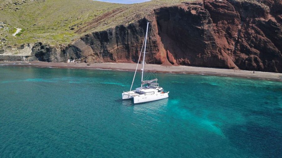 Santorini: Caldera Luxury Catamaran Cruise w/ Meal & Drinks - The sunset return toward Santorini’s Old Harbor