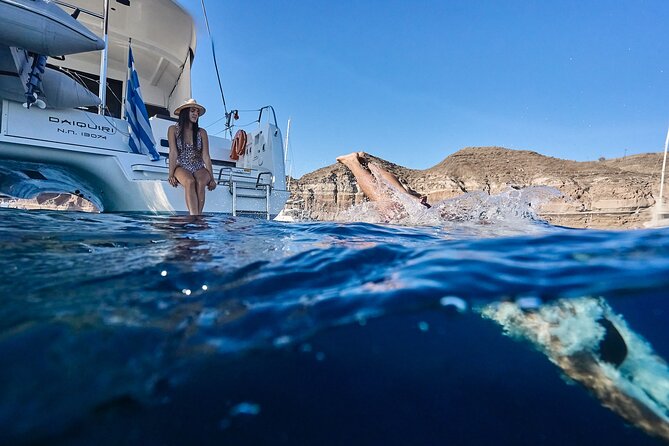 Santorini: Caldera Private Catamaran Cruise with Meal & Drinks - The southern lighthouse adds a scenic pause