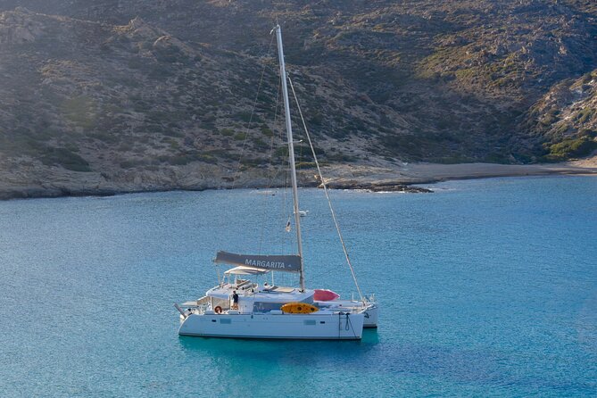 Santorini: Caldera Private Catamaran Cruise with Meal & Drinks - Red Beach shows Santorini’s volcanic side