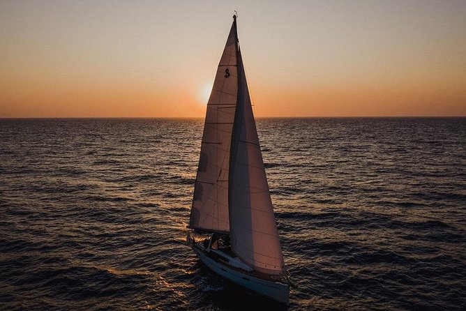 Santorini Caldera Private Sailing Boat Cruise - Akrotiri lighthouse and the southern cliffs