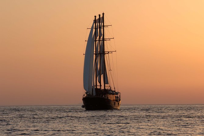 Santorini Caldera Sunset Sailing Cruise with Dinner and Wine - Palea Kameni: warm water, sulfur, and a 30-meter swim