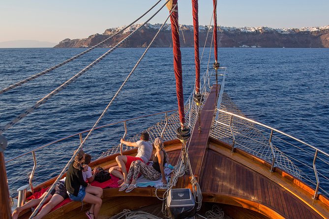 Santorini Caldera Sunset Sailing Cruise with Dinner and Wine - Sunset near Oia, viewed from the water