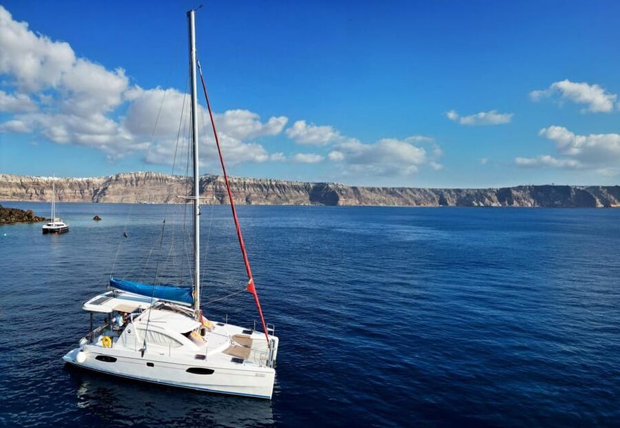 Santorini: Catamaran Cruise with Greek BBQ and Drinks - Red Beach: striking cliffs and the first swim