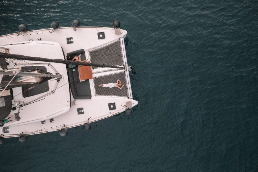 Santorini Catamaran Cruise with Swimming, Meal and Open Bar - Leaving Vlychada Marina and passing the southern coast