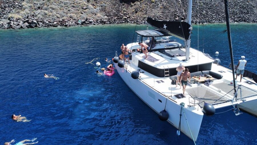 Santorini Catamaran Cruise with Swimming, Meal and Open Bar - Akrotiri Lighthouse and the caldera from the water