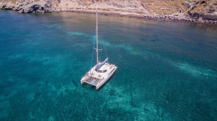 Santorini:Catamaran: private cruise with food & drinks - Around the lighthouse and into the Caldera