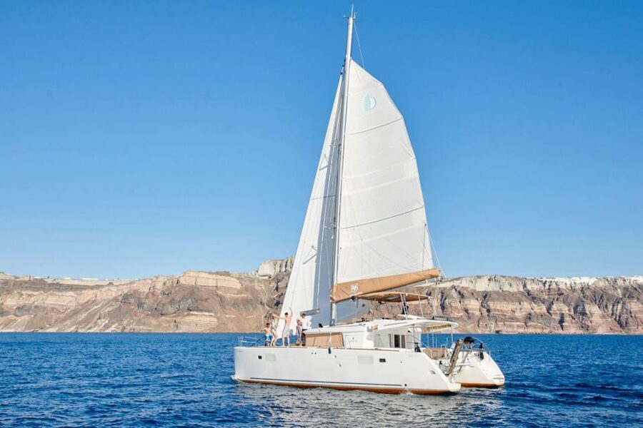 Santorini Gold Catamaran Cruise with Snorkel, BBQ & Open Bar - Caldera cliffs from sea level