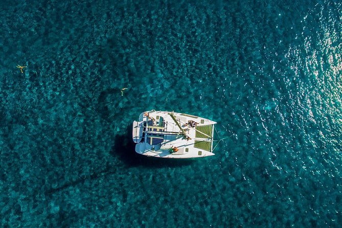 Santorini Half Day Catamaran Private Cruise incl. Meal, Drinks & Free Transport - The lighthouse and Aspronisi