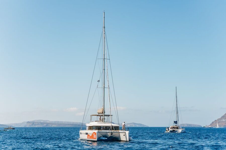 Santorini: Luxury Catamaran Day Trip with Meal and Open Bar - Pickup, port arrival, and the first hour