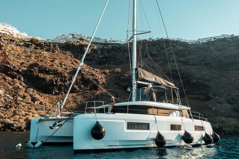 Santorini: Majestic Catamaran Cruise with Meal and Drinks - Red Beach, where the cliffs provide the scenery