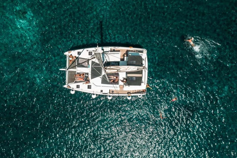 Santorini: Majestic Catamaran Cruise with Meal and Drinks - Ammoudi Bay and the first stretch of coastline
