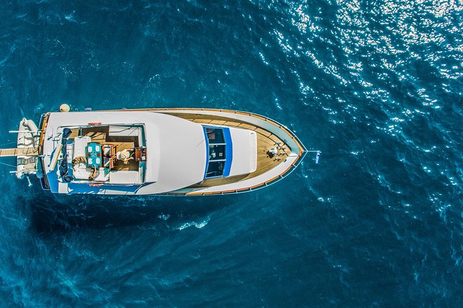 Santorini: Motor Yacht Sunset Cruise with 5-Course Dinner - Sailing out from Vlihada Port