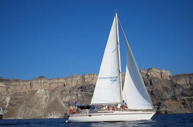 Santorini Oia: Private Sailing Yacht Cruise with Meal and Drinks - Seeing Santorini’s old port from offshore