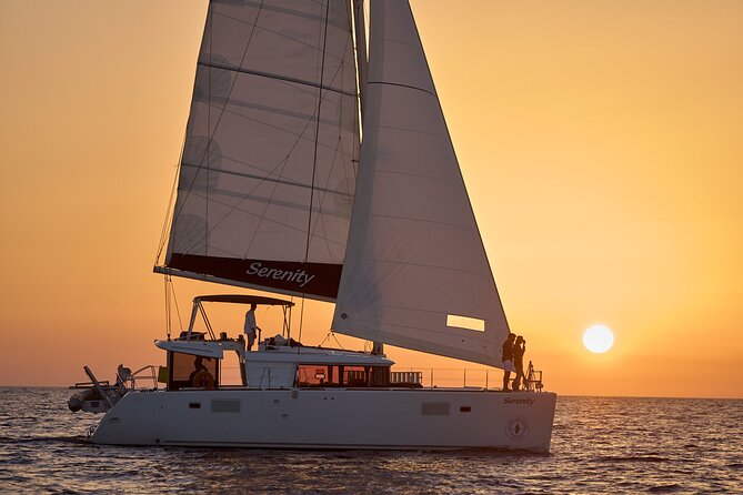 Santorini Oia: Private Sunset Catamaran Cruise with BBQ & Drinks - The lighthouse, old ports, and the final sunset position