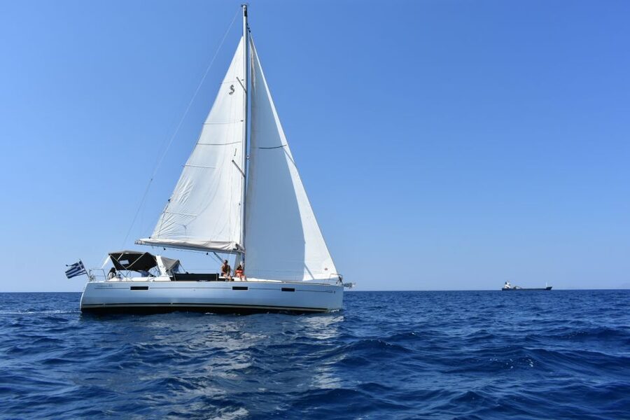 Santorini: Private Caldera Sailing Trip with Open Bar & Meal - Entering the caldera below the lighthouse