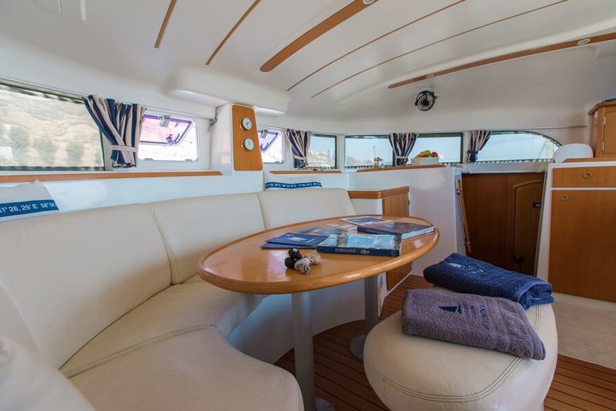Santorini: Private Catamaran Cruise with Food & Drinks - Lighthouse, Indian Rock, and the southern coast