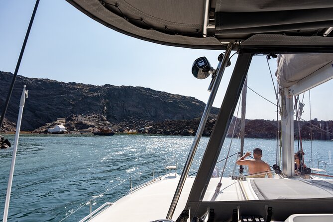 Semi Private Santorini Catamaran Tour - White Beach and the pale volcanic cliffs